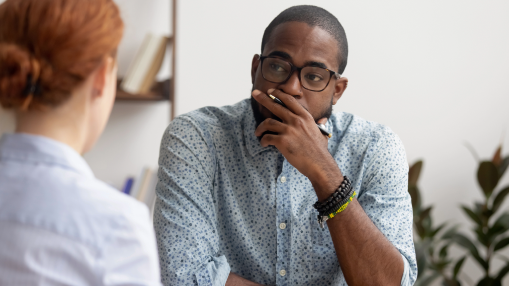 Hiring manager listening to a candidate in a second stage interview