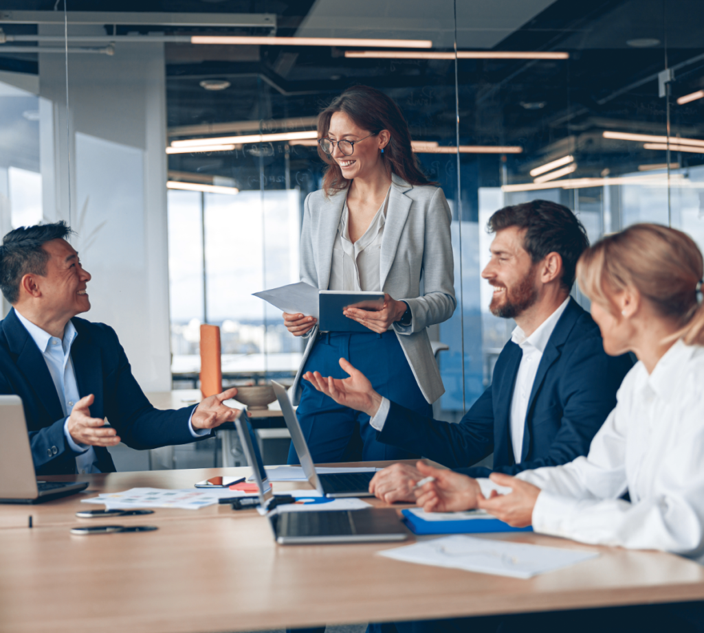 Hiring managers reviewing pay benchmarking data in a meeting