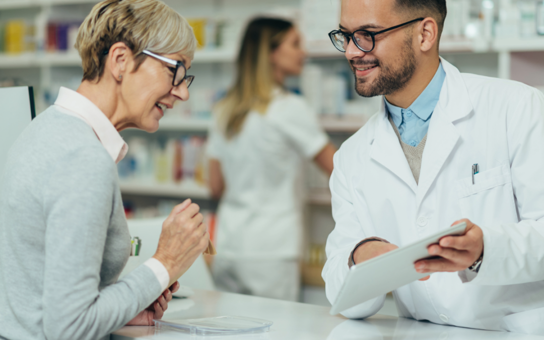 Two pharmacists reviewing candidate details on a tablet in a US pharmacy